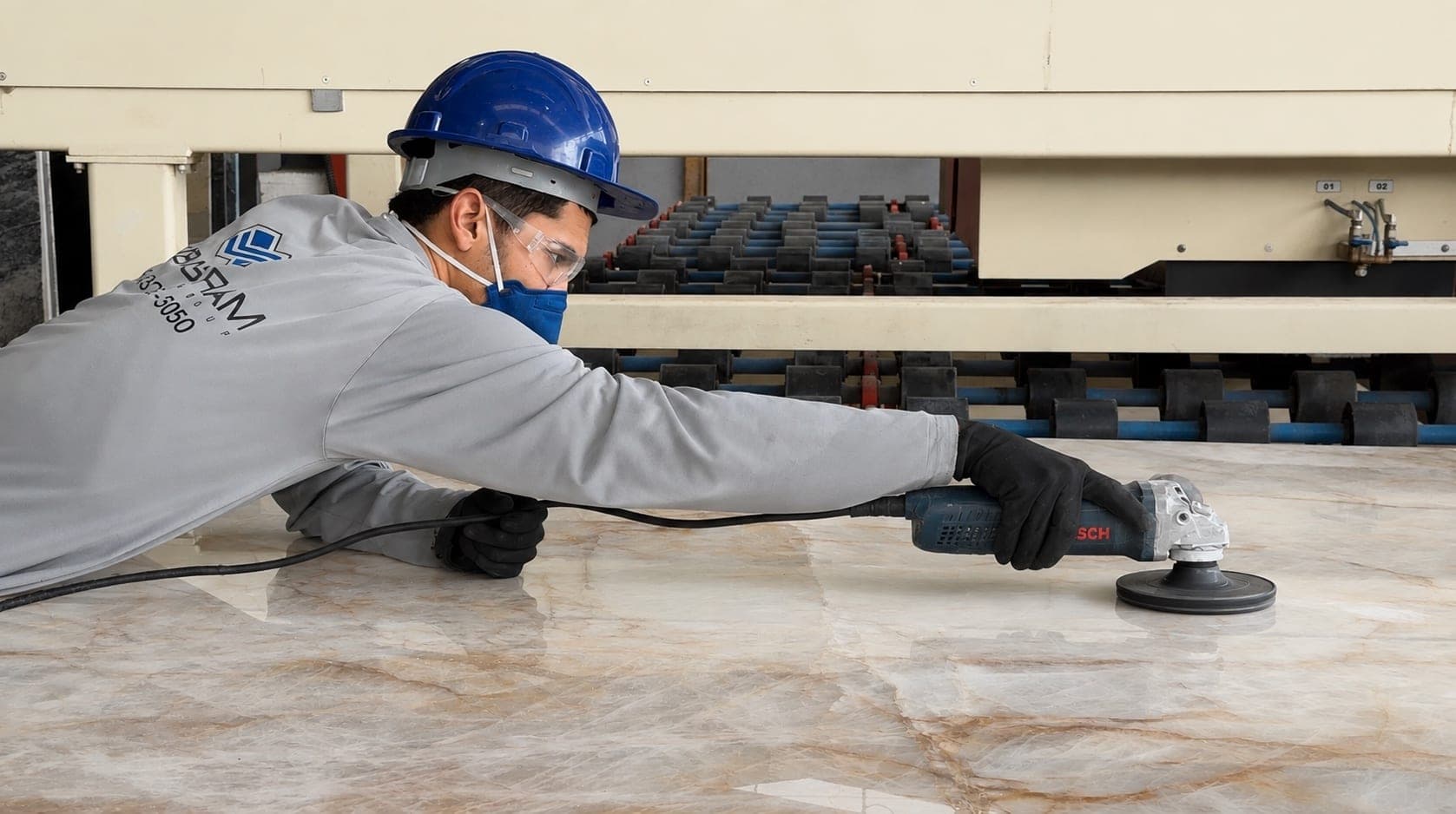 Polished slab being inspected before shipping.